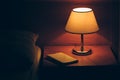 Vintage lamp on night table in hotel room Royalty Free Stock Photo
