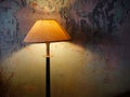 Vintage lamp shines on the background of a ruined wall