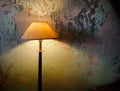 Vintage lamp shines on the background of a ruined wall. Mock up space Royalty Free Stock Photo