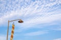 Vintage lamp on top of bamboo pole and yellow lanna flagTung on the blue sky in the morning Royalty Free Stock Photo