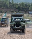 Vintage Land Rover Santana Series III vehicle in green with a tent on the roof rack in Suria, Spain