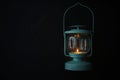 Vintage lantern with burning candle on black background. Space for text Royalty Free Stock Photo