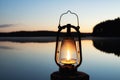 Vintage lantern near a lake. Beautiful calm lake on background. Royalty Free Stock Photo