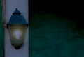 Vintage lantern shining bright light in the dark, home decorations and lighting Royalty Free Stock Photo