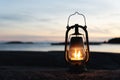 Vintage lantern at sunset, romantic evening at the beach. Royalty Free Stock Photo