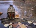 Vintage lantern on the tree in the autumn lake Royalty Free Stock Photo