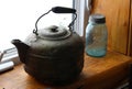 Vintage large antique metal kettle on windowsill