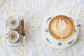 Vintage latte art coffee on table with sugar