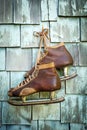 Vintage leather ice skates hanging on a wall