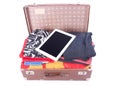 Vintage leather suitcase overstuffed with Tablet gadget Royalty Free Stock Photo