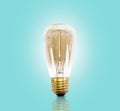 Vintage led light bulb on pastel blue background.