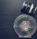 Vintage Lens with Movie Film roll on black background Royalty Free Stock Photo