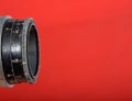 Vintage lens on red background Royalty Free Stock Photo
