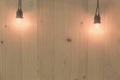 Vintage light bulbs hanging on wood wall Royalty Free Stock Photo