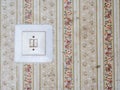 Vintage light switch with retro wallpaper Royalty Free Stock Photo