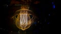 Vintage lightbulb on dark background with bright yellow shining wire.Close up of industrial lamp light.Illumination Royalty Free Stock Photo