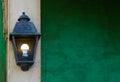 Vintage lighted lantern hanging on a stone pole, house decorations and lighting