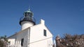 Vintage lighthouse tower, retro light house, old fashioned classic white beacon. Royalty Free Stock Photo