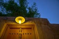 Vintage lighting fixture at dusk underneath a tree in Souq Wakrah, Qatar