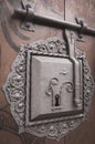 Vintage lock panel on door. Aged gate to medieval castle. Keyhole on old wooden door. Grunge security panel. Old ornate door.