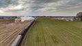 Vintage locomotive train chugging along railroad tracks in a scenic countryside setting Royalty Free Stock Photo