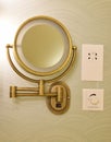 Vintage look brass adjustable wall mount magnifying mirror on half circle wallpaper