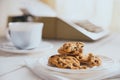 Vintage looking coffee with cookies and typing machine on a desk