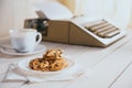 Vintage looking coffee with cookies and typing machine on a desk