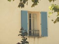 Vintage looking French window with cyan blue shutters