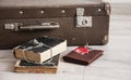 Vintage luggage with blank space of photo frame and stack old books on wooden table. Journey memory concept Royalty Free Stock Photo