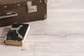 Vintage luggage with blank space of photo frame and stack old books on wooden table. Journey memory concept Royalty Free Stock Photo