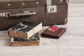 Vintage luggage with blank space of photo frame and stack old books on wooden table. Journey memory concept Royalty Free Stock Photo