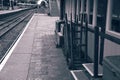 Vintage luggage trolleys and suitcases outside the waiting room of an old railway station Royalty Free Stock Photo