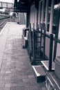 Vintage luggage trolleys and suitcases outside the waiting room of an old railway station Royalty Free Stock Photo