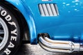 Vintage luxury cupercar Ford Shelby AC Cobra detail close-up, wheel and chrome exhaust pipes