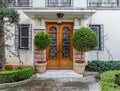 A vintage, luxury house entrance solid wood door with huge flower pots Royalty Free Stock Photo