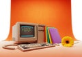 Vintage macintosh computer setup with colorful books and a bright yellow flower Royalty Free Stock Photo