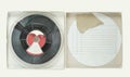 Vintage magnetic audio reel in cardboard box and blank paper inlay, free copy space