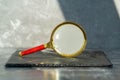 Vintage magnifier on dark background, side view