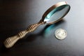 Vintage Magnifying Glass And Old Silver Coins On Black Table