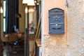 Vintage mailbox full of advertising newspapers at the door of the building, selective focus, italy
