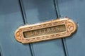 Vintage mailbox inlaid in a blue wooden door