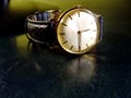 Vintage male watch on leather top desk