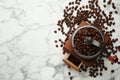 Vintage manual coffee grinder with beans on white marble table, flat lay. Space for text Royalty Free Stock Photo