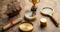 Vintage Map with Golden Compass, Ship, Magnifier and Scroll Royalty Free Stock Photo