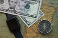 Vintage map of South America with five dolor bills, watch and a compass, close-up