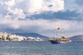 Vintage mast wooden sailing ship for sea tours in port of Saranda, Albania on the background of Saranda town. Cloudy day. Sea Royalty Free Stock Photo