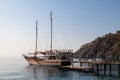 Vintage mast wooden sailing ship for sea tours. Touristic pirate ship in port. Marina in in resort city Kemer, Turkey. Old harbour