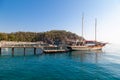 Vintage mast wooden sailing ship for sea tours. Touristic pirate ship in port. Marina in in resort city Kemer, Turkey. Old harbour Royalty Free Stock Photo