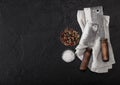 Vintage meat knife hatchets on kitchen towel and black stone table background. Butcher utensils. Salt and pepper